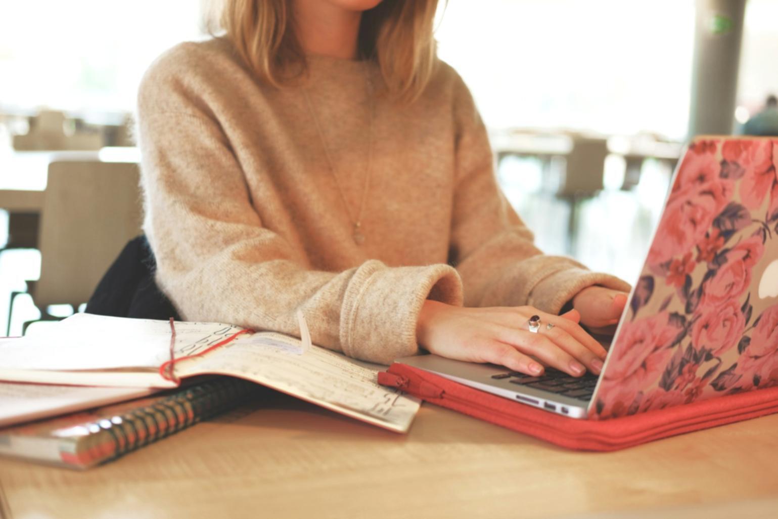 Person reviewing financial documents with calculator and charts